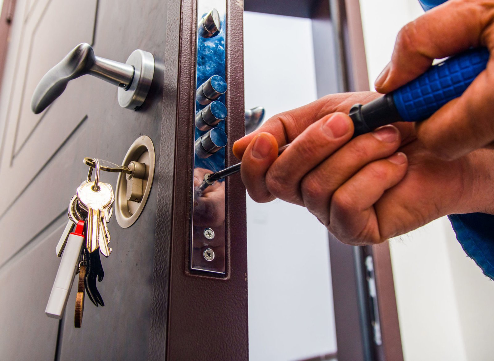 Locksmith technician performing emergency door lock repair in San Diego