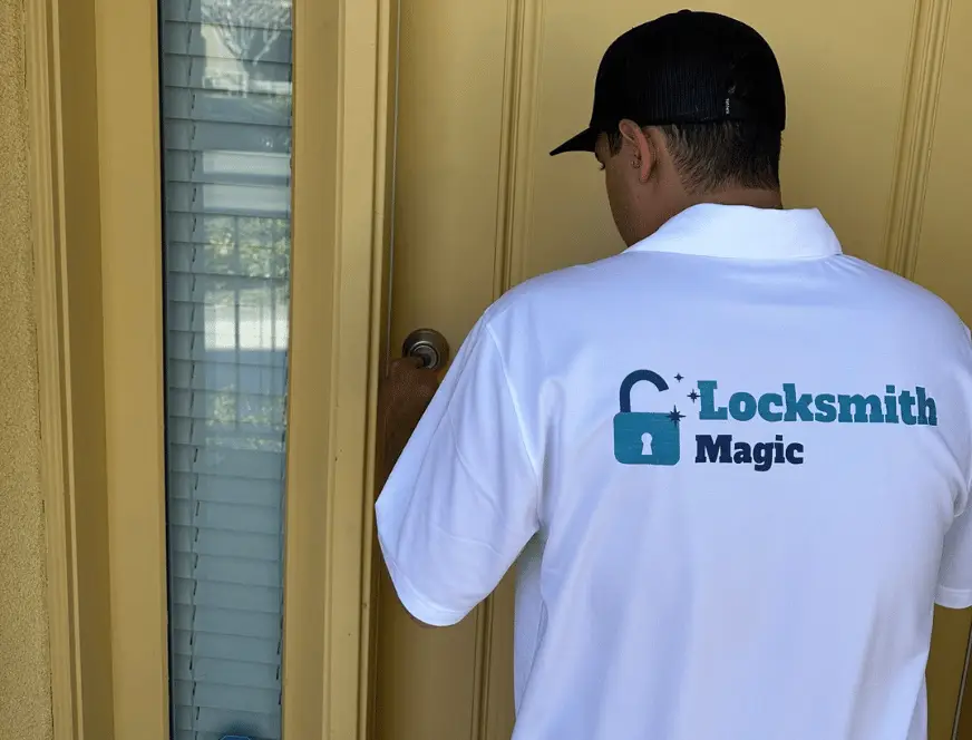 Locksmith Magic technician in branded shirt working on a door lock in San Diego