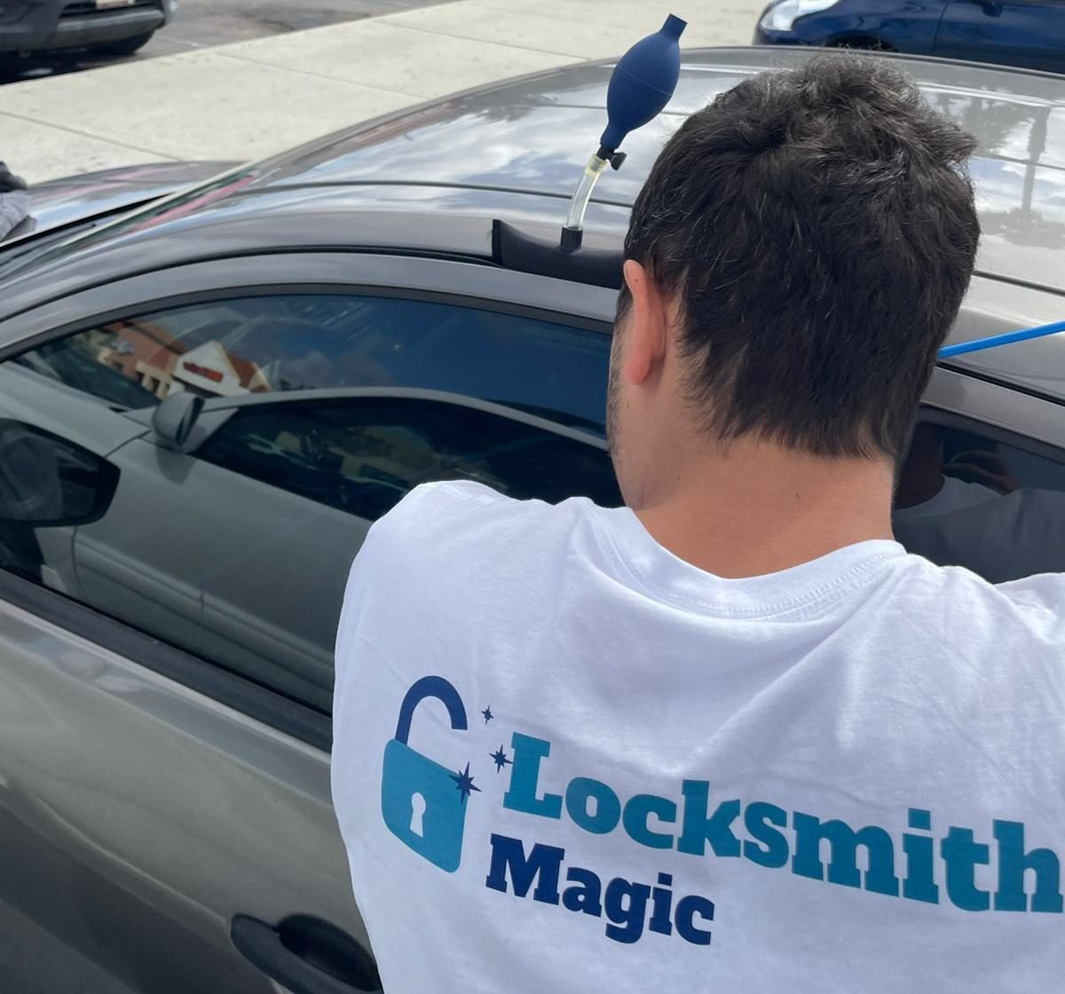 Locksmith Magic technician using an air wedge to open a car door in San Diego