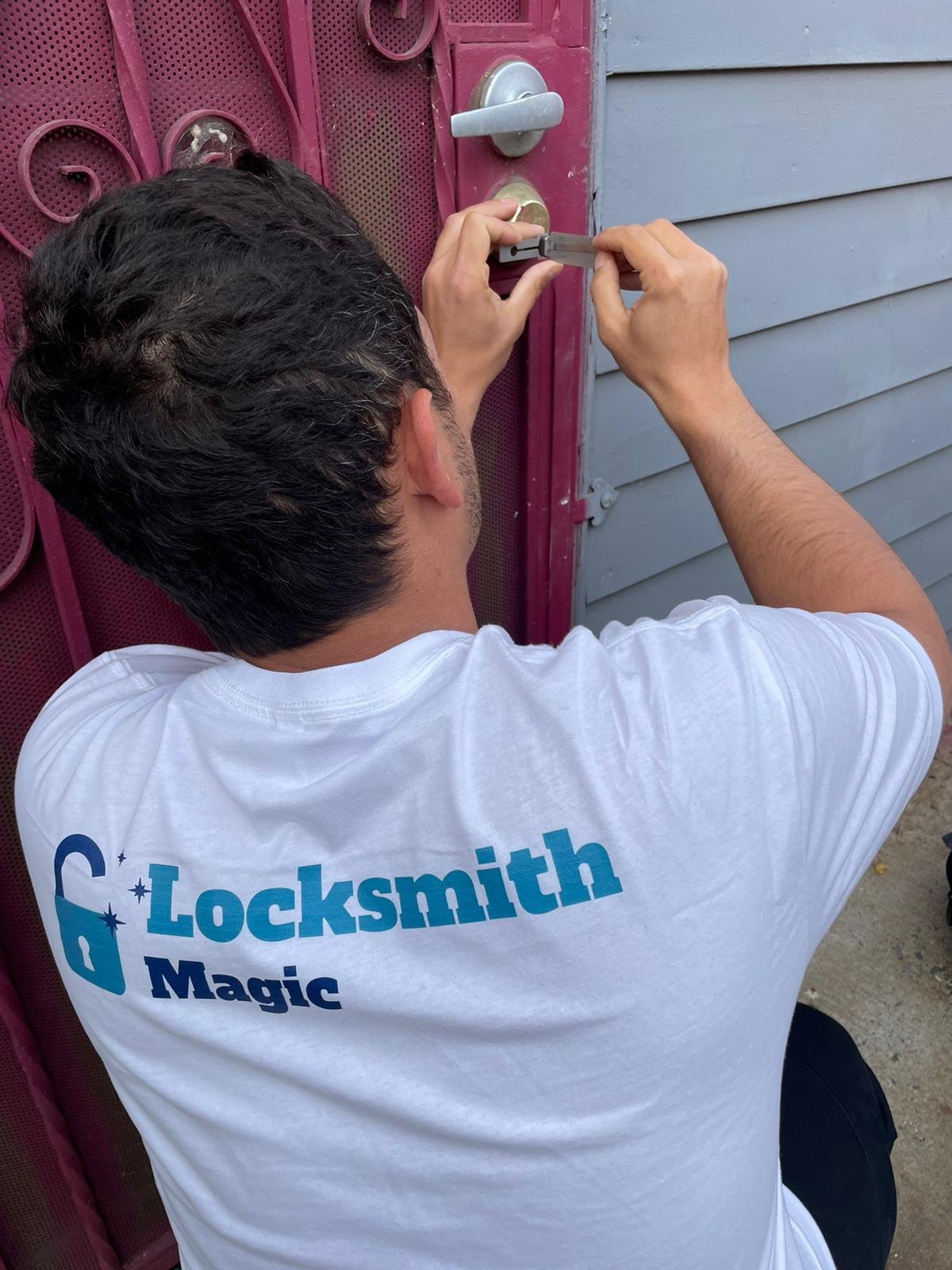 Locksmith Magic technician picking a residential door lock