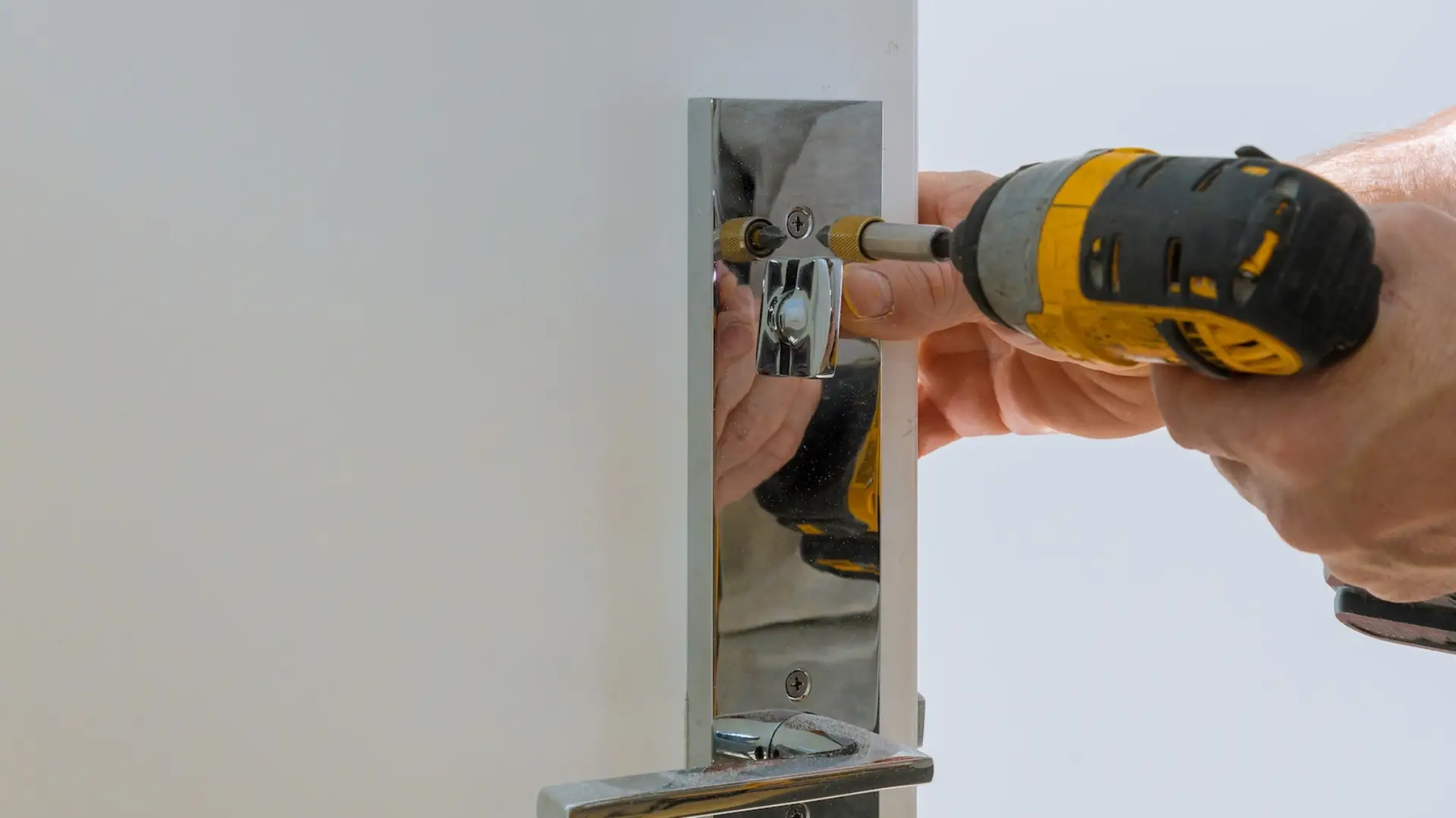 Locksmith fixing a home door lock during a house lockout