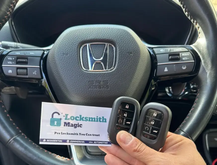 Honda key fob at steering wheel with Locksmith Magic business card
