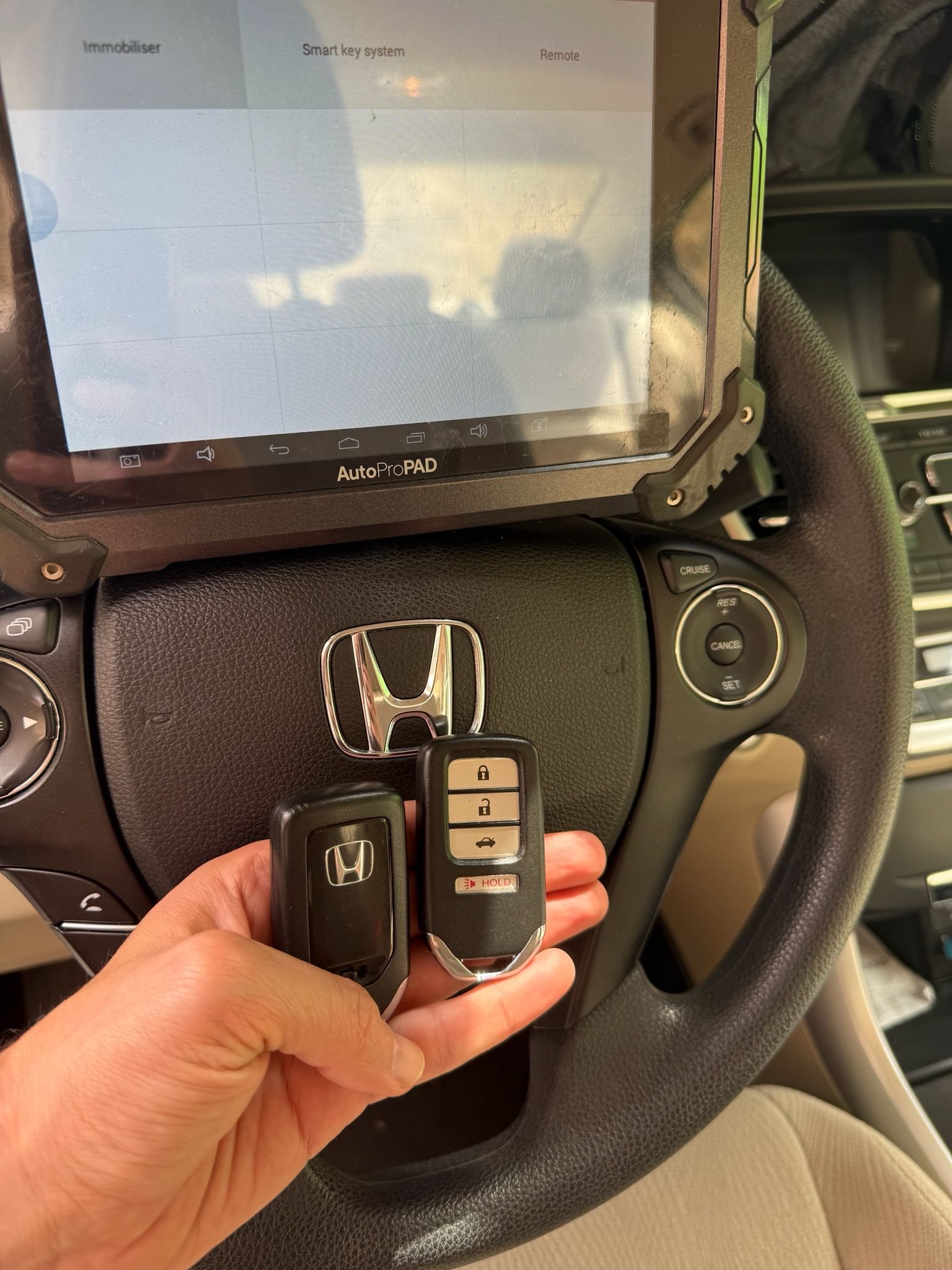 Key fob programming on a car dashboard by Locksmith Magic
