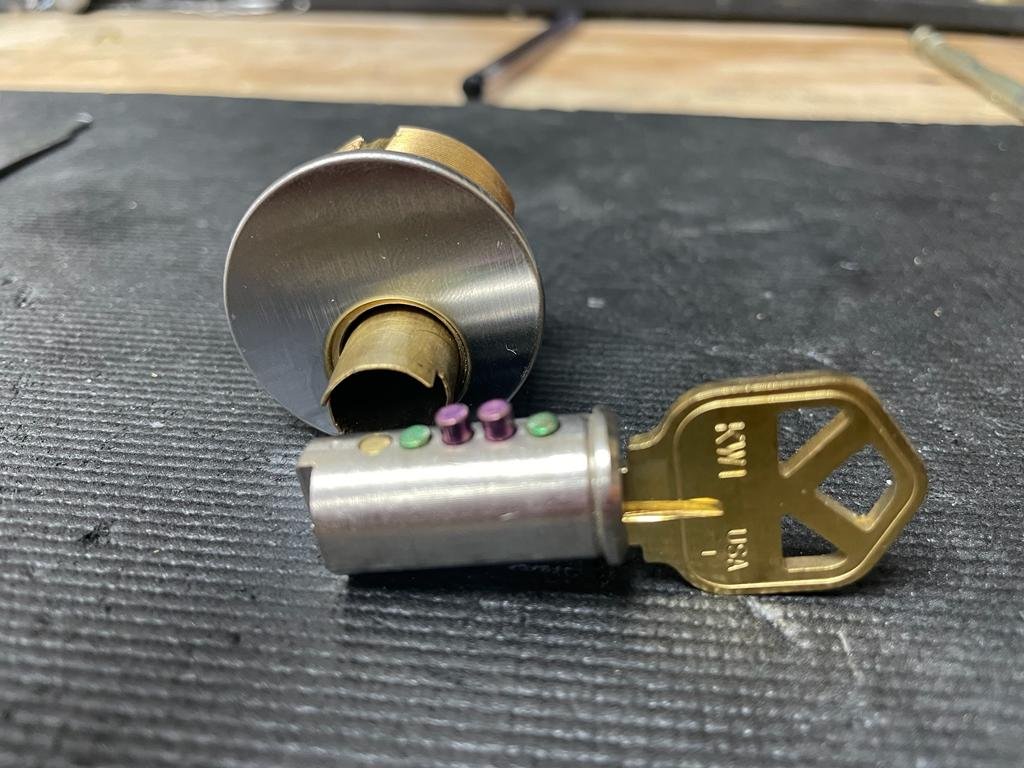 Disassembled lock cylinder showing pin tumblers for rekeying